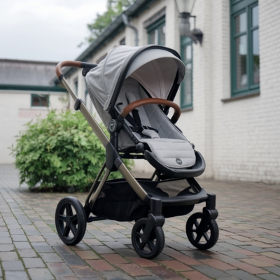 Versatile gray stroller with leather-accented handles and a modern design, ideal for parents balancing urban and suburban lifestyles.