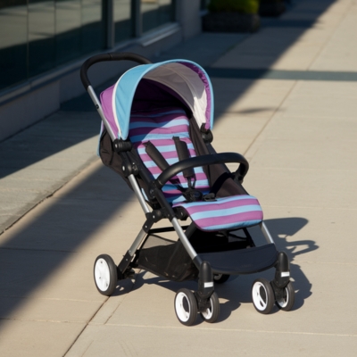 A purple and blue striped lightweight stroller sits on a paved walkway, positioned for easy maneuverability and convenience in urban settings.